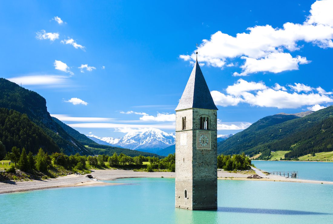 tower of sunken church in Resia lake, South Tyrol, Italy